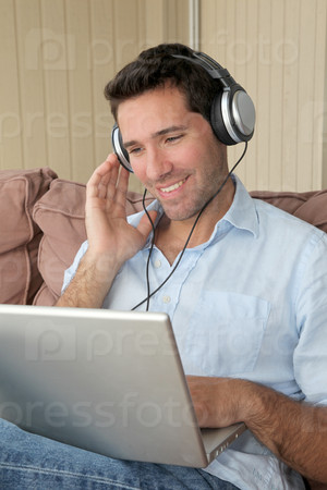 Handsome man listening to music on internet