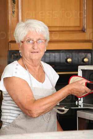 Elderly woman in home kitchen