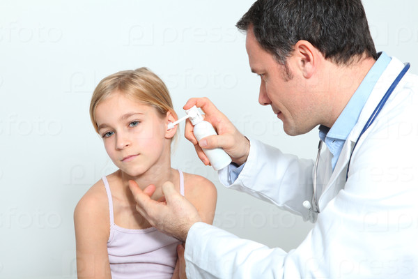 Doctor treating little girl ear infection