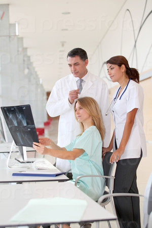 Group of medical people looking at xray