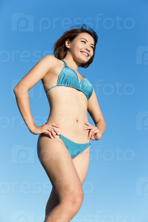 Happy girl wear bikini at sea beach and smile, asian beauty