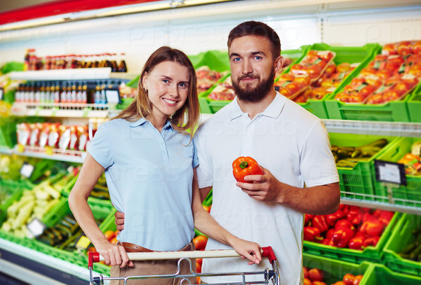 Young couple buying products in supermarket