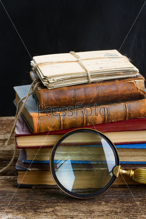 pile of books with looking glass