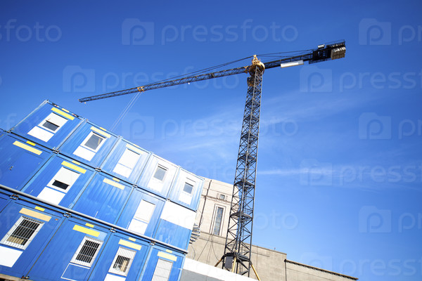 Lifting crane on building