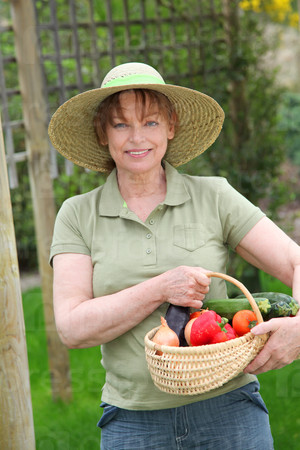 Senior woman standing in kitchen garden
