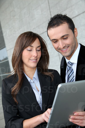 Business people meeting outside with electronic tablet