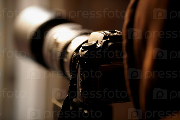 With telephoto Lens,natural sunset light, selective focus on camera parts, stock photo