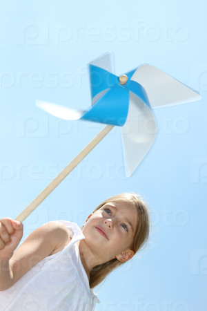 Closeup of little girl blowing blue wind wheel