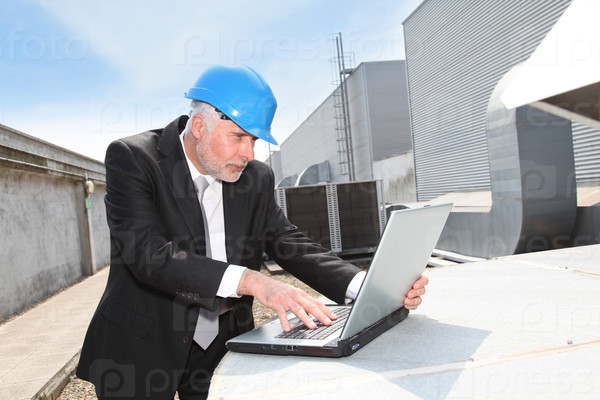 Businessman checking industrial site