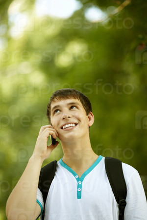 Portrait of young man with cell-phone ,ambient light and silver reflection, stock photo