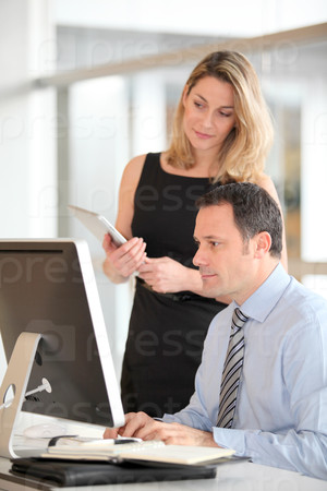 Office workers in front of computer