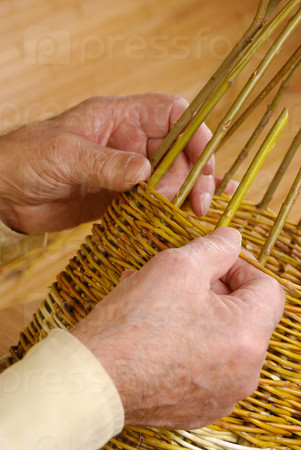 Old man\'s hands and wicker basket