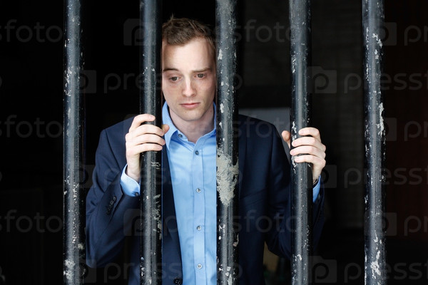 Businessman in jail, stock photo