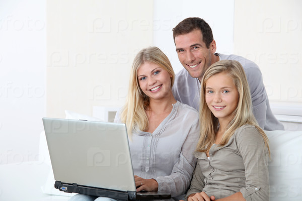 Family at home in front of computer
