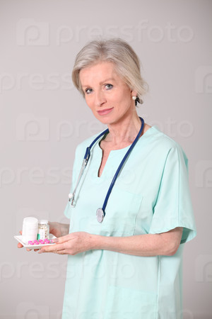 Closeup of senior nurse standing on white background