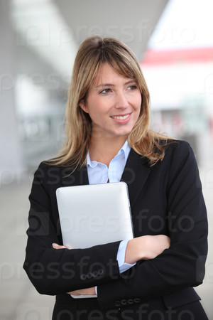 Smiling businesswoman with electronic tablet