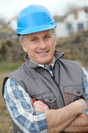 Portrait of smiling engineer with blue security helmet