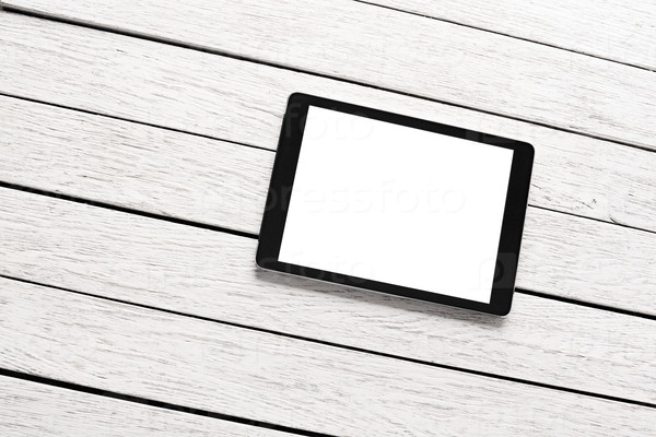 Tablet computer on white wooden desk. Clipping path included.
