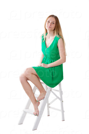 girl in a green dress sitting on stepladder