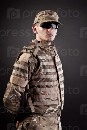 Half length portrait of adult man in his US Army uniform; copy space on black background