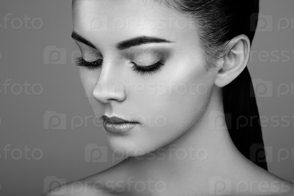 Beautiful woman face. Perfect makeup. Beauty fashion. Eyelashes. Cosmetic Eyeshadow. Highlighting. Black and white, stock photo