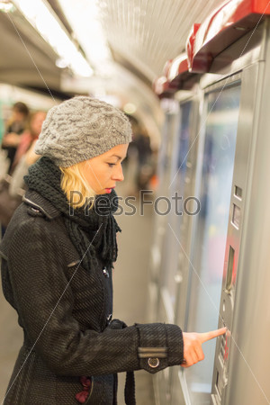 Lady buying ticket for public transport.