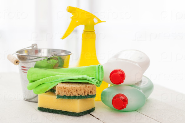 Bright colorful cleaning set on a white wooden table, stock photo