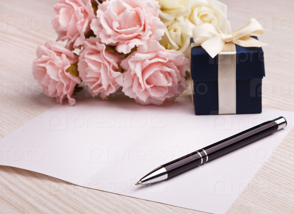 blank card with pen, blue gift box, pink and white roses