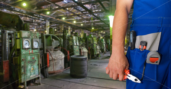 Worker with instruments at industrial factory