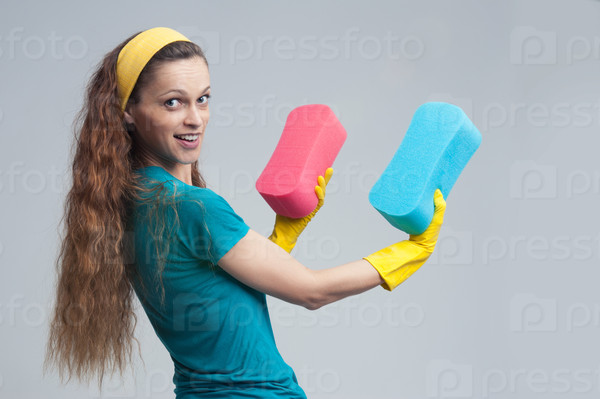 happy caucasian cleaning woman standing and holding sponge