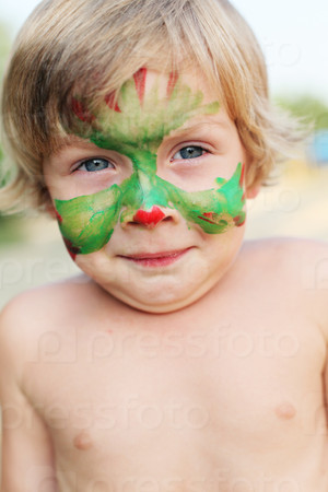boy child with a painted mask on her face