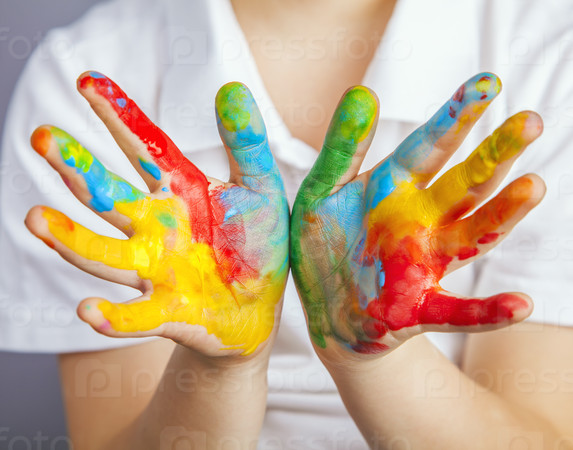 little girl and boy hands painted in colorful paints