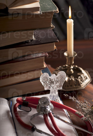 stethoscope, cup of tea, books, candle. Still life. Concept health