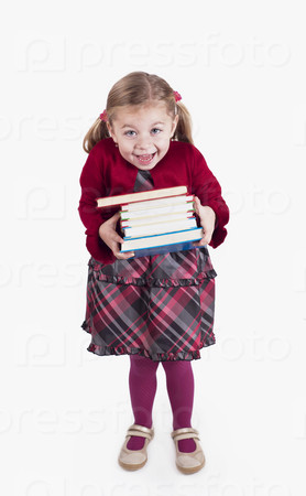 Little girl holding books preparing to go back to school - isolated