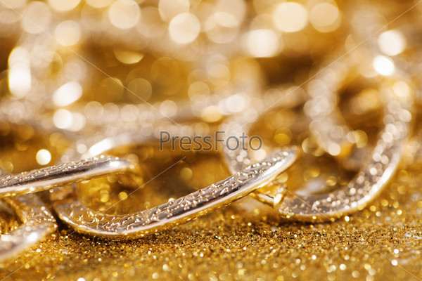 close up of golden chainlet. gold luxury jewelery.
