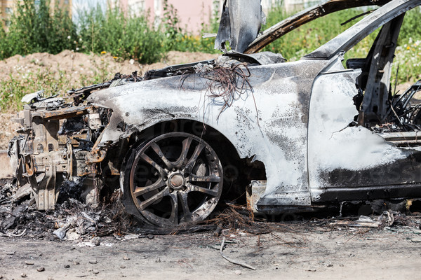 Road wreck accident or arson fire burnt wheel car vehicle junk, stock photo