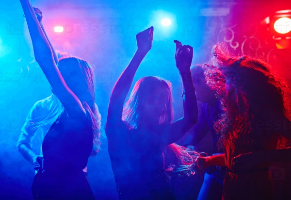 Girlfriends dancing at disco in nightclub