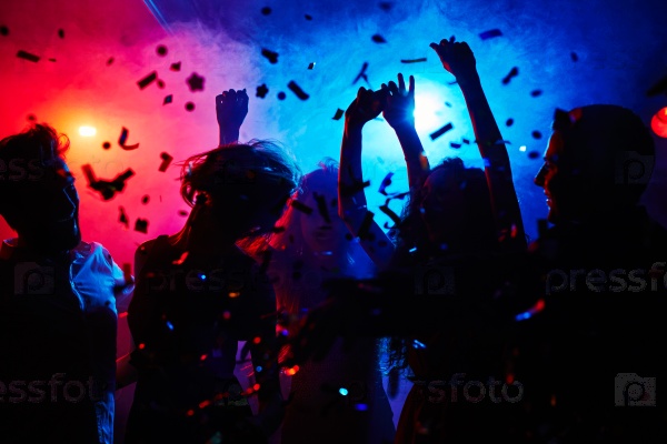 Silhouettes of dancers moving in confetti, stock photo