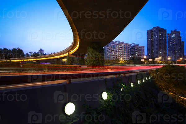 high-speed urban viaduct construction night view car light\
trails