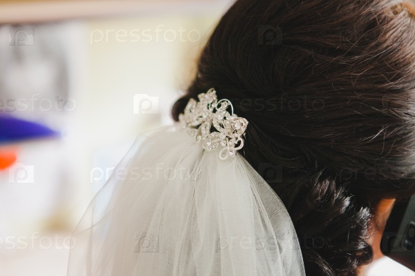 Bride\'s hair, styled with a hair ornament.