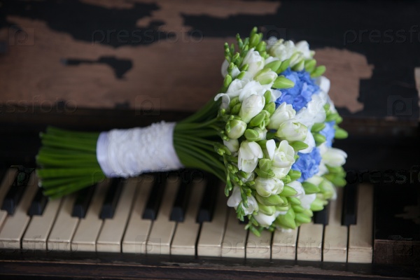 Wedding bouquet for bride on the vintage piano