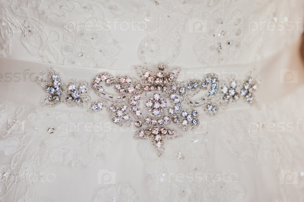 Bridal belt with shiny rhinestones on a luxurious white wedding dress