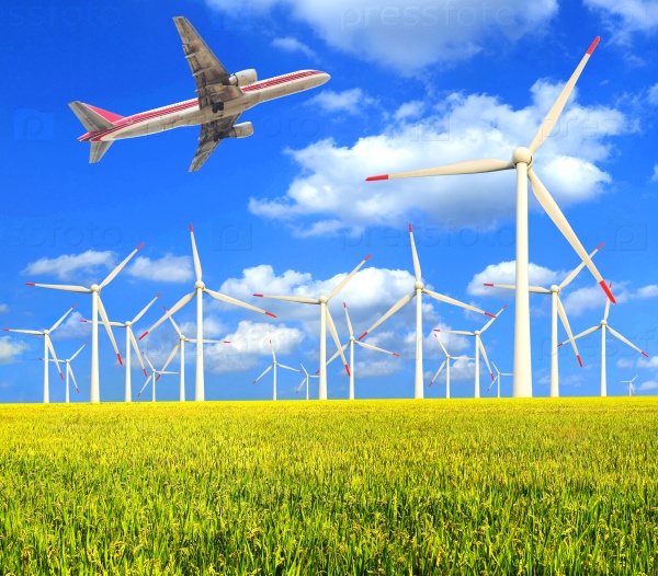 Aircraft is flying in the environmentally friendly power generation wind turbines in the rice farms at concept
