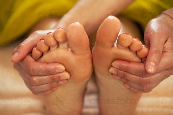 Foot massage for a woman in a luxury spa