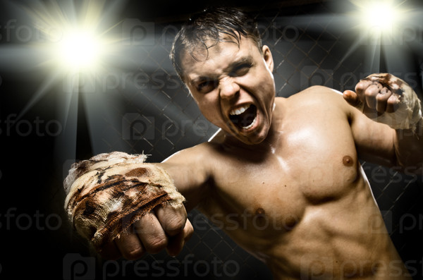 horizontal  photo  muscular young  guy street-fighter, cuff  fist close up on camera and yell , hard light