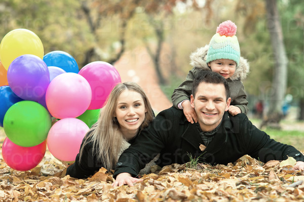 happy family with little child and air-balloons, outing in autumn park