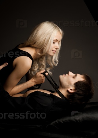 muscular handsome sexy guy with pretty woman, on dark background