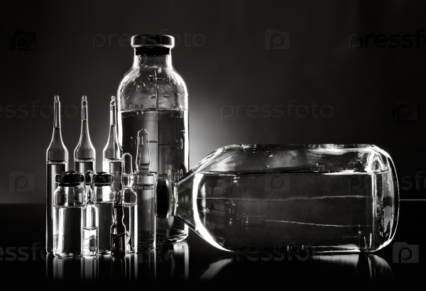 group object of  liquid medicinal agent in  limpid glassware, black-and-white horizontal photo