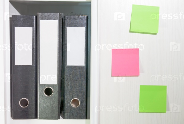 Folders for documents on a book shelf