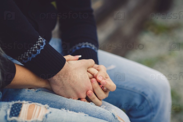 Young couple in love walking in the autumn park holding hands in hands